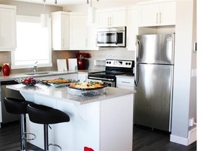The compact, well-designed kitchen at a show home at Arrive at Redstone by Partners Development Group has a backsplash that says elegance. Andrea Cox for the Calgary Herald