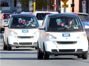 A couple of car2go cars make their way in downtown Calgary.