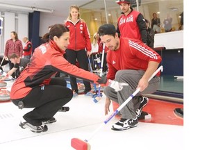 Curler Jill Officer gives some pointers to bobsled pilot Nick Poloniato during a team building exercise at the Glencoe Club on Thursday.