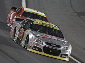 Dale Earnhardt Jr (88) leads Kevin Harvick (4) during the NASCAR Sprint Cup series Bank of America 500 auto race at Charlotte Motor Speedway in Concord, N.C., Saturday, Oct. 11, 2014.