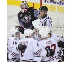 The Red Deer Rebels celebrate a goal on Calgary Hitmen netminder Mack Shields in Saturday’s home opener.