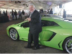 Developer Ken Mariash stands among the luxury cars during an event launching a new Meadows Mile auto mall overlooking Deerfoot Meadows.