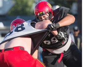 Dinos offensive lineman Ryan Sceviour (#58) battles defensive lineman James Bradley (#99) during training camp.