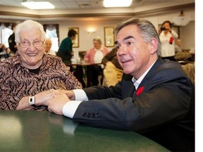 EDMONTON, ALBERTA ; OCTOBER 29, 2014--Premier Jim Prentice speaks to Kadie Bunio who turns 103 on Thursday, after he and Seniors Minister Jeff Johnson announce that $70 million will be put into upgrading sprinkler and fire safety systems in older government-owned seniors facilities on October 29, 2014. (Greg Southam/Edmonton Journal)