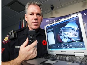 Evel Kiez, acting Sgt. with the Calgary Police Service, displays a body-worn camera during the pilot project held in November, 2012. The camera will become standard equipment for the city’s police officers, beginning in December.