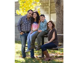 Fadi Yacoub, left, his wife, Ralda Daher, right, and their two children, Perla and Fouad, in Calgary on Friday, Oct. 10, 2014. Yacoub and his family recently arrived in Canada after fleeing the violence in Syria.