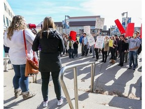 ‘Fight tuition hikes’ protest co-organizers Laurie Gaal, left with megaphone, and Jennifer West, next to her, voice their issues and guide protesters in chant at Mount Royal University in Calgary, on October 9, 2014.