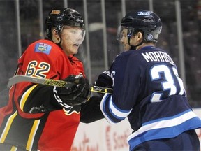 Flames prospect Austin Carroll jousts with Josh Morrisey of the Winnipeg Jets during the second period in Young Stars Classic in Penticton, B.C. on Friday night.