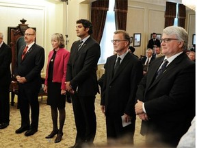 From left, new ministers Stephen Mandel, Ric McIver, Maureen Kubinec, Stephen Khan, Gordon Dirks and David Dorward attend the swearing-in ceremony at Government House on Monday.