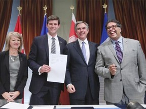 From left, Municipal Affairs Minister Diana McQueen, Edmonton Mayor Don Iveson, Alberta Premier Jim Prentice and Calgary Mayor Naheed Nenshi pose for a photo after signing a city charter framework agreement at City Hall in Calgary on Oct. 7, 2014.