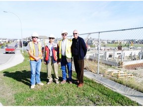 From left, the Swan Group’s senior site supervisor Dennis Lechler, director of developments Vincent Liu, president Richard Li and general manager Mike Butt recently gathered at the Swan Evergreen Village site where work has begun on a new building for seniors who require assisted living. Claire Young/Calgary Herald