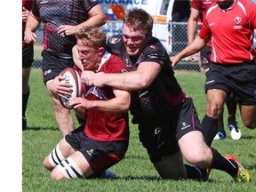 Gordon McRorie of the Prairie Wolf Pack brings down Grant Crowell of the Atlantic Rock during their Canadian Rugby Championship match on Sunday in Calgary.