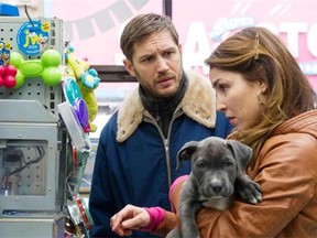 Tom Hardy, left, as Bob, Zora the dog and Noomi Rapace as Nadia in The Drop: “The director called her a broken angel,” Rapace says of her character. “She is fragile, and struggling … but good.” Barry Wetcher/20th Century Fox.