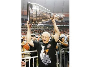 Head coach Wally Buono celebrates with the Grey Cup after the B.C. Lions beat the Winnipeg Blue Bombers 34-23 to win the CFL 99th Grey Cup November 27, 2011 at BC Place in Vancouver, British Columbia, Canada. Buono will be inducted into the Canadian Football Hall of Fame on Sunday, Sept. 21, 2014.