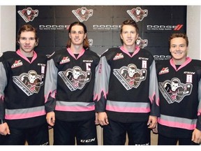 The Hitmen’s leadership group, from left, includes Colby Harmsworth, new captain Kenton Helgesen, Adam Tambellini and Elliott Peterson.