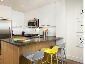 The kitchen features stainless-steel appliances and polished quartz counters.