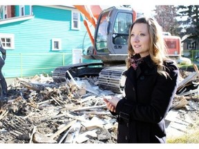 Jocelyn Rempel in front of what was her 102-year-old dream house, which was condemned after the 2013 flood.