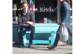 Kricket’s owner Dan Faassen sits on a bench as part of the Bench Project which mysteriously appeared in front of his Mission store on Wednesday.