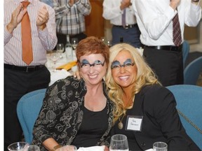 Melodie Creegan, left, and Tara Robinson of Mosaic Communications show off their “David Parker” eyebrows at the David Parker Appreciation Night event.