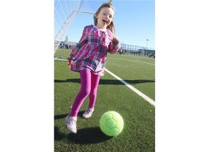 Melina Marceau, 4, takes a spin with a soccer ball while watching her brother play on one of the new fields as the Calgary Soccer Centre hosted a grand opening on Saturday, October 18, 2014. The centre has seven new fields, three outdoors and four inside the new annex.