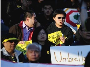 Members of the Calgary Hong Kong Political Reform Awareness Group and Friends of Hong Kong gather at Olympic Plaza in Calgary on October 1, 2014 to show solidarity for Hong Kong protesters.