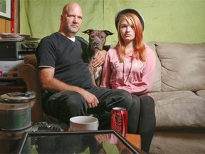 Michael Dion, right, his daughter Brianna, 17, and their pit bull Zeus, are pictured in their mobile home, which has been sold. They are having trouble finding a new accommodation and will be homeless at the end of October if they do not find something soon.