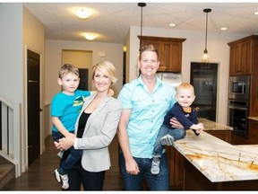 Geoff and Aleisha Anderson, holding their sons Austin and Hunter, bought a Jayman MasterBuilt home in Sunset Ridge with a solar rough-in that will allow them to install solar panels at a later time.