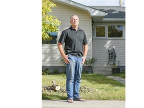 Murray Ost, community association head of Glenbrook, stands in front of a home in his community whose owner has applied to put in a secondary suite.