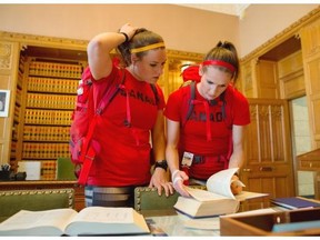 CTV 
 Natalie Spooner, left, and Meaghan Mikkelson work on a challenge in the offices of the Speaker of the House of Commons, the Hon. Ed Scheer, on the second season finale of The Amazing Race Canada.