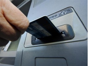 A customer uses an automated teller machine. Bank tellers and cashiers are jobs that have been supplemented with automated counterparts - what other jobs could face replacement by machines?