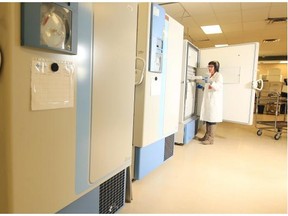 Sherry Kells, a research assistant at Alberta Cancer Research Biorepository, pulls blood samples out of ultra low temperature freezers stored as part of the Tomorrow Project biorepository, in this file photo from December 17, 2013.