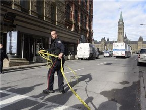 Police cordon off a street leading to Parliament Hill in Ottawa on Wednesday Oct. 22, 2014. THE CANADIAN PRESS/Adrian Wyld