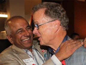 Victorious candidate Gordon Dirks gets an embrace from Mike Shaikh at his victory party after winning the byelection in the Calgary-Elbow riding Monday night.