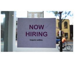 A hiring sign is seen July 5, 2013 in Old Town Alexandria, Virginia.