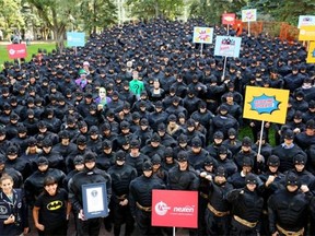 Nexen Energy employees in Calgary cheer after setting the Guinness World Record for the largest gathering of people dressed as batman.