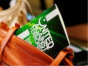 A copy of the handbook United Against Terrorism sticks out of a purse Monday during the released of the publication this week in Winnipeg.