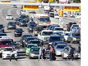 Pedestrians cross Macleod Trail near Chinook Centre on October 5, 2014. Transportation engineers say Macleod Trail will still be able to handle “reasonably high volumes” of traffic in keeping with redevelopment plans the city has on the table, however the speed limit would be reduced.