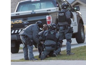 Police arrest a man after a day-long standoff in northwest Calgary, on October 25, 2014.

Police arrest a man after a day-long standoff in northwest Calgary, on October 25, 2014.