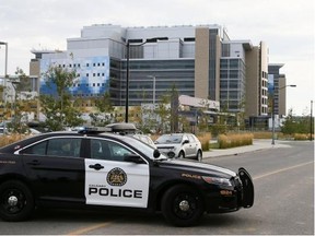 Police block the entrance to the South Calgary Health Campus as they search for a cougar last Thursday. The animal was later shot by Fish and Wildlife officers.