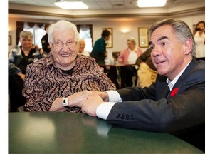 Premier Jim Prentice speaks to Kadie Bunio who turns 103 on Thursday, after he and Seniors Minister Jeff Johnson announce that $70 million will be put into upgrading sprinkler and fire safety systems in older government-owned seniors facilities on October 29, 2014.