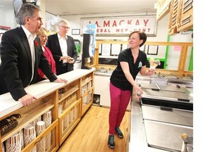 Premier Jim Prentice, his wife Karen and Agriculture Minister Verlyn Olson ordered some ice cream from Mackay’s Ice Cream owner Meghan Tayfel after a news conference in Cochrane about rural economic development on Tuesday.