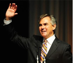 Jim Prentice waves from the stage after the results of his 77% victory are announced in Edmonton.