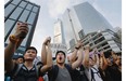 Protesters shout slogans outside a flag-raising ceremony where Hong Kong’s embattled leader attended in Hong Kong on Wednesday, Oct. 1, 2014, to mark China’s National Day.