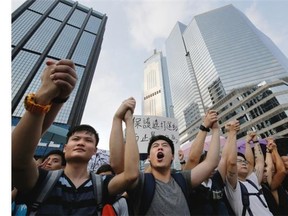 Protesters shout slogans outside a flag-raising ceremony where Hong Kong’s embattled leader attended in Hong Kong on Wednesday, Oct. 1, 2014, to mark China’s National Day.
