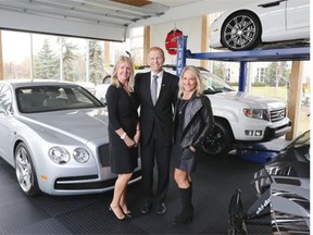 Realtors Wynn Alex Carr, left and Corinne Poffenroth of Sotheby’s International Realty Canada stand with Concord Pacific Developments vice-president of sales Grant Murray in the garage show suite for the The Concord condo development in Eau Claire.