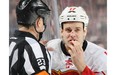 Referee Brad Watson checks out a cut suffered by Lance Bouma of the Calgary Flames after a high stick during a game against New Jersey last April. Bouma is one of the most fearless players in the NHL, constantly putting his body on the line.