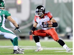 Saskatchewan Roughriders linebacker Chad Kilgore tries to tackle Calgary Stampeders running back Jon Cornish in Regina on Friday.