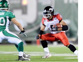 Saskatchewan Roughriders linebacker Chad Kilgore tries to tackle Calgary Stampeders running back Jon Cornish during a game in Regina earlier this month. Cornish won’t play against the Riders on Friday in Calgary.