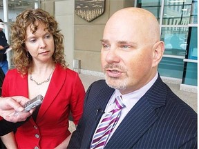 Ian Savage (right), president of the Criminal Defence Lawyers Association from Calgary, speak to reporters at the Calgary Courts Centre on Monday, March 31, 2014 about changes to traffic court.