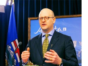 Don Scott, Alberta's associate minister for accountability, transparency and transformation, speaks to reporters at the legislature Friday, Jan. 31, 2014 just before his department posted online the names and salaries of the government's 3,100 top money-earners. The disclosure is the result of Premier Alison Redford's pledge to release such data to make sure both government staff and taxpayers are getting a fair deal. THE CANADIAN PRESS/Dean Bennett
